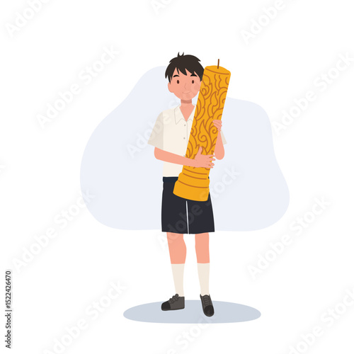 thai schoolboy holding large wax candle for buddhist holiday celebration in thailand cultural festival and asian tradition.