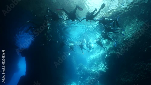 people are making a circle to make a pose for fotograph in an underwater cave
