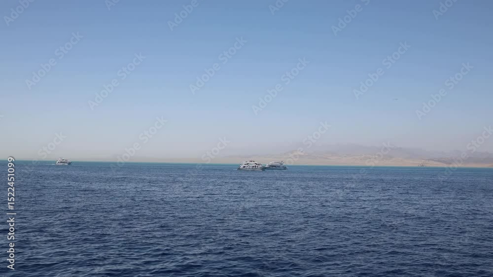 Red Sea yachts turquoise shallows sandy coast distant haze desert mountains soft sky open water peaceful cruise scene calm marine escape sunlit travel destination in Egypt Red Sea yachts turquoise shallows sandy coast distant haze desert mountains soft sky open water peaceful cruise scene calm marine escape sunlit travel destination in Egypt