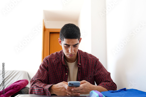Young man engaged in daily smartphone routine