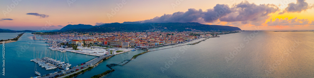 Fototapeta premium Lefkas (Lefkada) town, amazing view at the small marina for the fishing boats with the nice wooden bridge and promenade, Ionian island, Greece