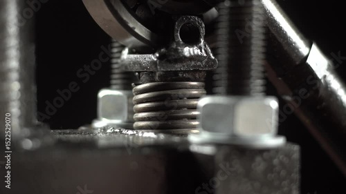 Vertical press spring moves up and down during compression process.