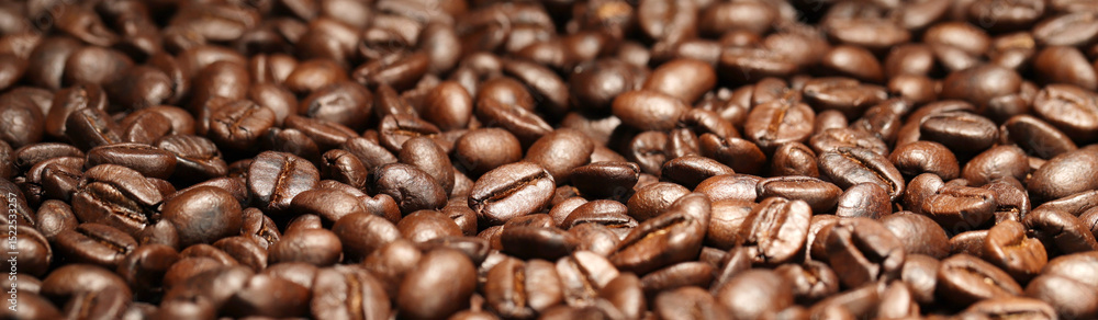Fototapeta premium Coffee texture of fresh roasted beans close up. Food photo for backdrops or recipes.
