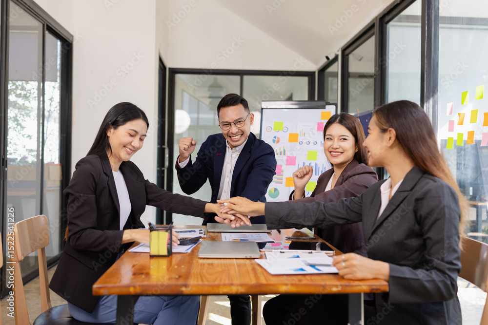 Group of Asian businesspeople Join hands and work together as a team in modern office, Business startup and company strategy planning concept. Group of Asian businesspeople Join hands and work together as a team in modern office, Business startup and company strategy planning concept.