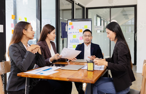 Group of Asian business working plan analysis project brainstorm in modern office, Asian businesspeople team working together, Business startup and company strategy planning concept.
