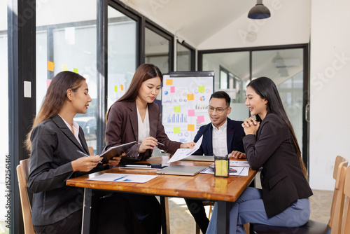 Group of Asian business working plan analysis project brainstorm in modern office, Asian businesspeople team working together, Business startup and company strategy planning concept.
