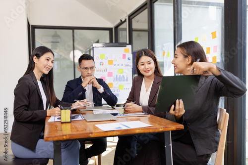 Group of Asian business working plan analysis project brainstorm in modern office, Asian businesspeople team working together, Business startup and company strategy planning concept.
