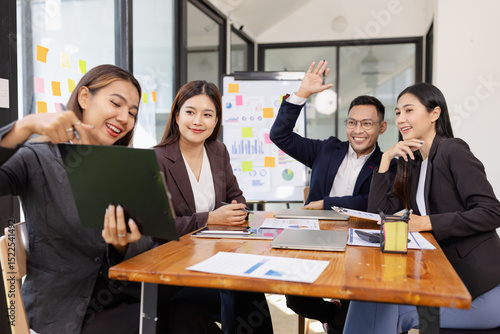 Group of Asian business working plan analysis project brainstorm in modern office, Asian businesspeople team working together, Business startup and company strategy planning concept.
