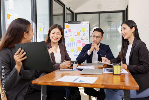 Group of Asian business working plan analysis project brainstorm in modern office, Asian businesspeople team working together, Business startup and company strategy planning concept.
