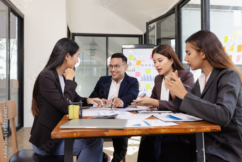 Group of Asian business working plan analysis project brainstorm in modern office, Asian businesspeople team working together, Business startup and company strategy planning concept.
