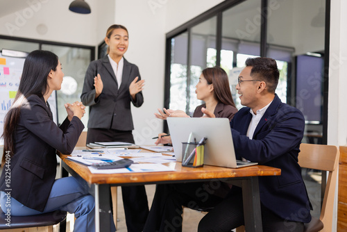 Group of Asian business working with analysis project brainstorm in modern office, Asian businesspeople team working together, Business startup and company strategy planning concept.