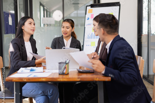 Group of Asian business working with analysis project brainstorm in modern office, Asian businesspeople team working together, Business startup and company strategy planning concept.