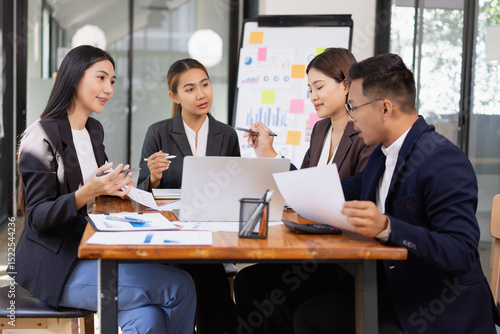Group of Asian business working with analysis project brainstorm in modern office, Asian businesspeople team working together, Business startup and company strategy planning concept.