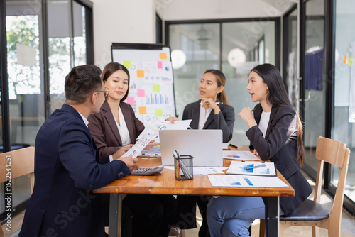 Group of Asian business working with analysis project brainstorm in modern office, Asian businesspeople team working together, Business startup and company strategy planning concept.