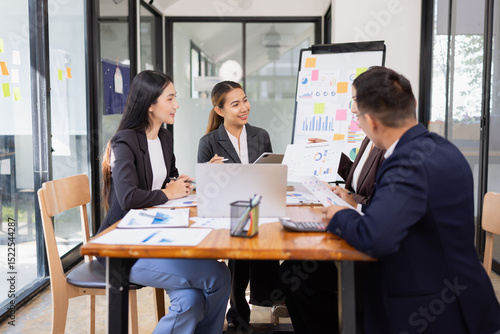 Group of Asian business working with analysis project brainstorm in modern office, Asian businesspeople team working together, Business startup and company strategy planning concept.