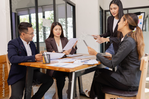Group of Asian business working with analysis project brainstorm in modern office, Asian businesspeople team working together, Business startup and company strategy planning concept.