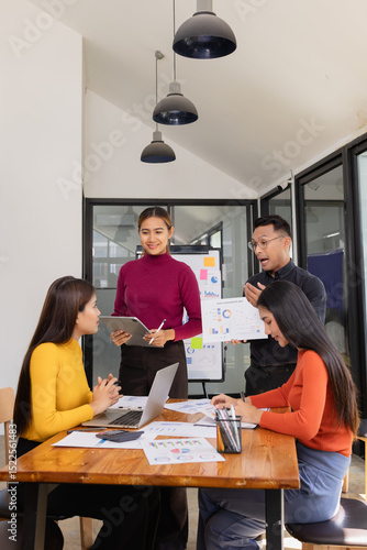 Group of Asian business people working together to presentation with dashboard analysis data management a meeting table in office, Business investment metrics or planning concept. 