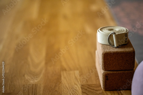Obraz na plátně a yoga block and a yoga belt wit space around on a wooden ground