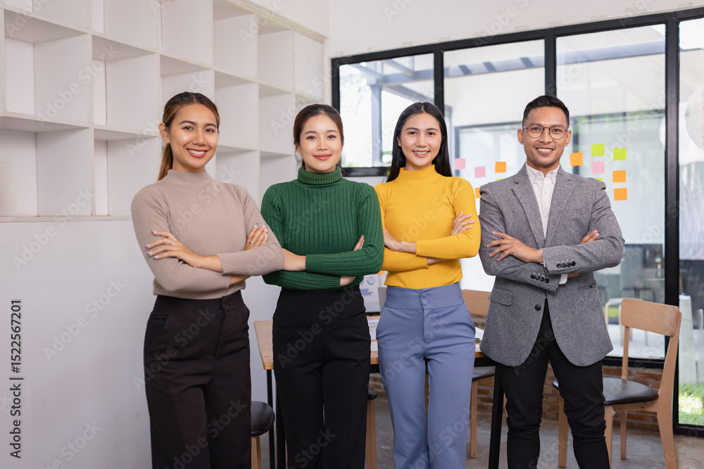 Obraz premium Group of Asian businesspeople look at camera together standing in modern office, Business startup and company strategy planning concept.