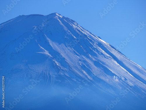 Snow-covered slopes of Mount Fuji on a clear sunny day