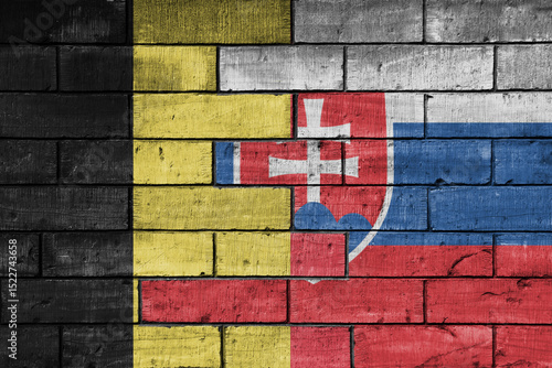 Photography colourful painted big national flag of slovakia and flag of belgium on a massive old brick wall background