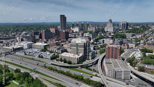Cars and trucks driving through Albany, NY downtown beside Hudson river and past rural neighborhoods 