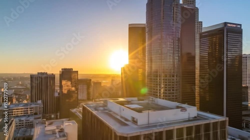 Breathtaking Aerial view of Los Angeles skyline at sunset with glowing golden sun