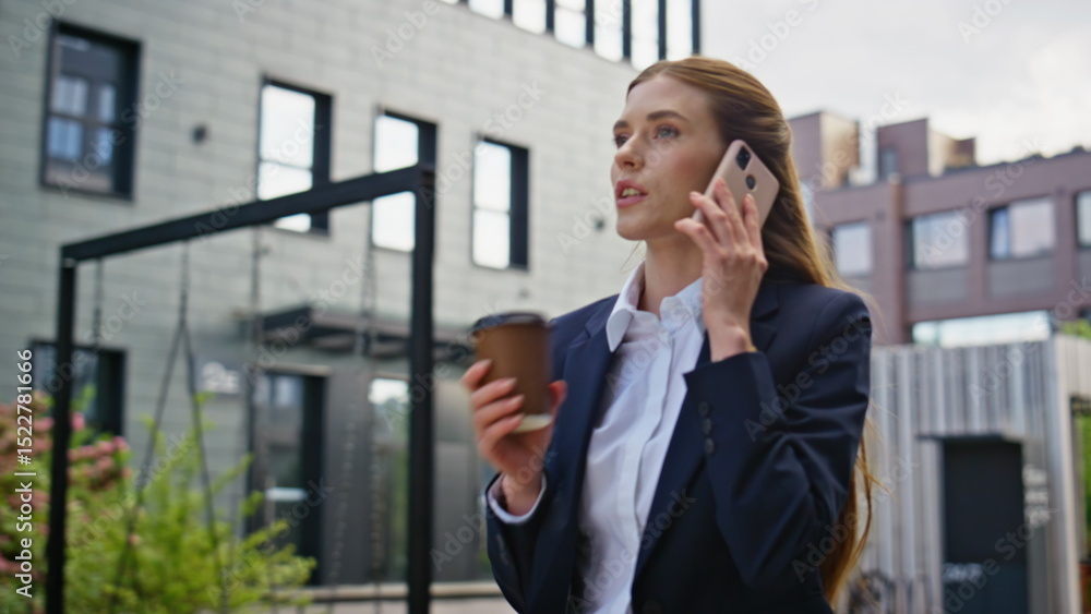 Energetic businesswoman calling cellphone walking street with coffee closeup. Energetic businesswoman calling cellphone walking street with coffee closeup.