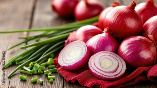 This vibrant image showcases fresh red onions alongside chopped chives on a wooden table, emphasizing healthy ingredients commonly used in culinary dishes.