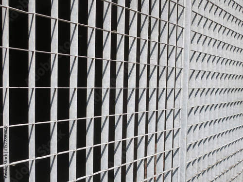 iron gate with rectangle shapes of shadow