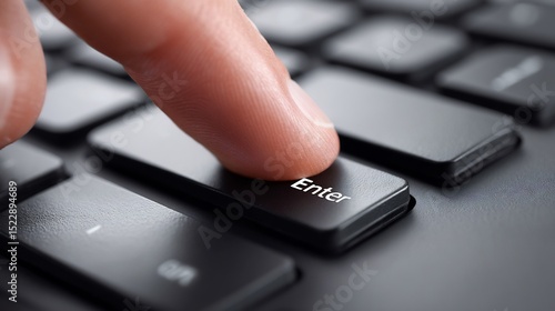 Finger presses the enter key on a computer keyboard.