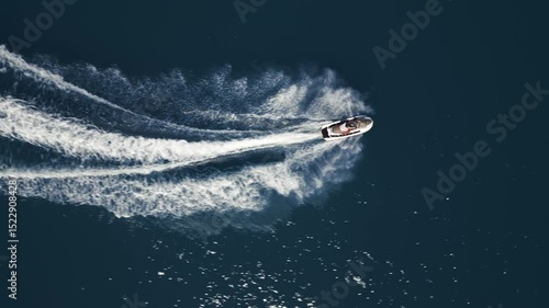 Wallpaper Mural Aerial view of a jet ski speeding across dark blue water, leaving a dynamic white trail. Captured by drone from above, showcasing motion, power, and summer fun on the sea Torontodigital.ca