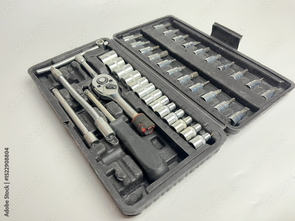 Great studio shot of various tools, socket wrenches arranged in a box. Great studio shot of various tools, socket wrenches arranged in a box.