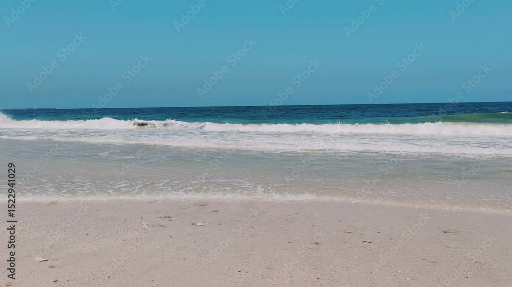 Water waves Sea Shore Beautiful Panorama white sand beach and turquoise water View. Holiday summer beach background, Wave of sea on White sandy beach. Timelapse Heavy Water Waves on Sandy Public Beach Water waves Sea Shore Beautiful Panorama white sand beach and turquoise water View. Holiday summer beach background, Wave of sea on White sandy beach. Timelapse Heavy Water Waves on Sandy Public Beach
