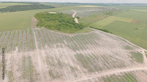Drone shot, high angle view over the construction site of a photovoltaic park. Construction site for ground-mounted solar photovoltaics. Renewable energy, low carbon concept.