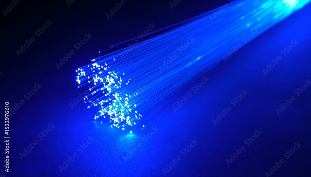 Obraz premium Glowing blue fiber optic strands on dark background. Abstract technology image. Perfect for backgrounds, websites, or presentations.