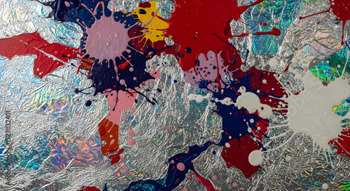 Vibrant Splashes Of Color On A Textured Silver Foil Background