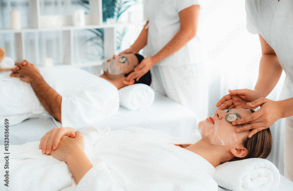 Obraz premium Serene daylight ambiance of spa salon, couple customer indulges in rejuvenating with luxurious cucumber facial mask. Facial skincare treatment and beauty care concept. Quiescent