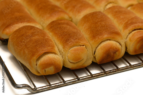 фотографія Golden Parker House Rolls Resting on Wire Rack After Baking