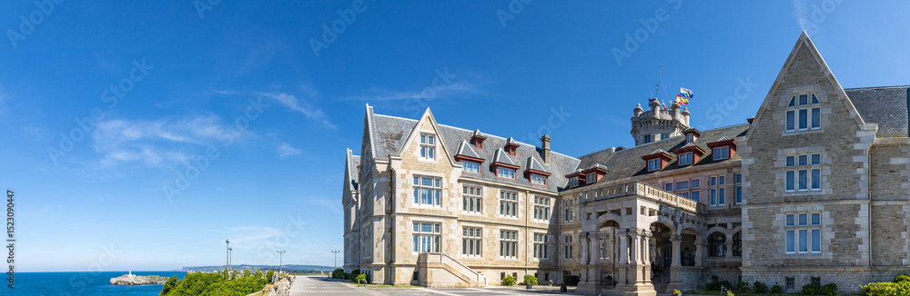 Naklejka premium Panoramic photograph of the Magdalena Palace, a prime example of majestic architecture surrounded by natural surroundings. Santander, Spain