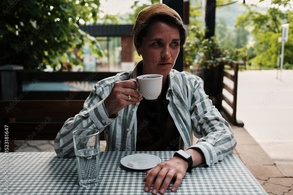 Woman enjoying a cup of strong Serbian coffee at an outdoor cafe in Tara National Park. Woman enjoying a cup of strong Serbian coffee at an outdoor cafe in Tara National Park.
