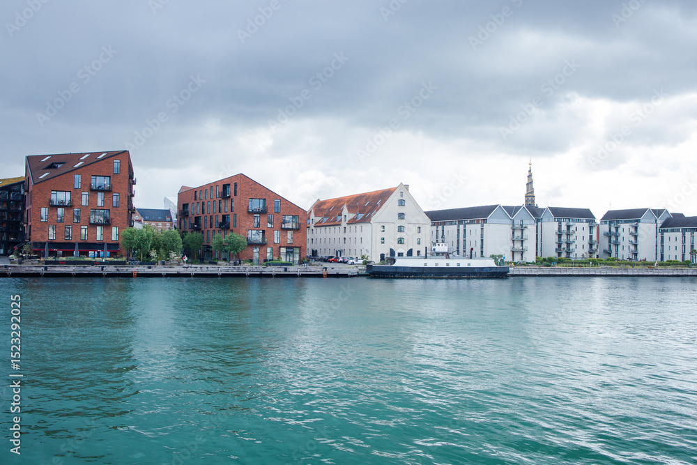 Canal and modern buildings of Christianshavn neighborhood of central Copenhagen, Denmark. Panoramic view from the bridge. Canal and modern buildings of Christianshavn neighborhood of central Copenhagen, Denmark. Panoramic view from the bridge.