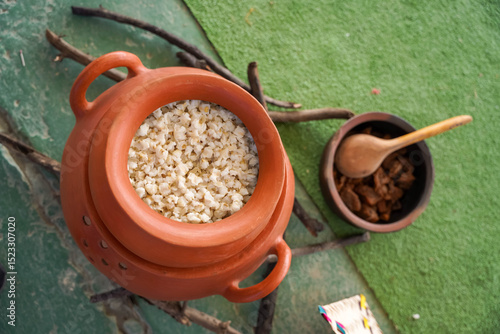 The essence of ancestral cuisine with mote and chicharrón served in authentic clay pots