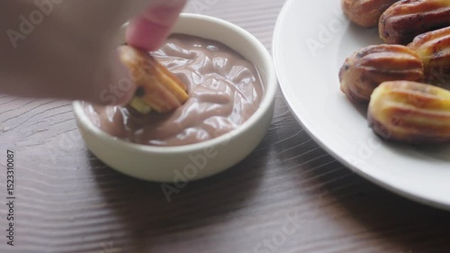 Close-up of churros dessert on a white vintage plate and hot chocolate