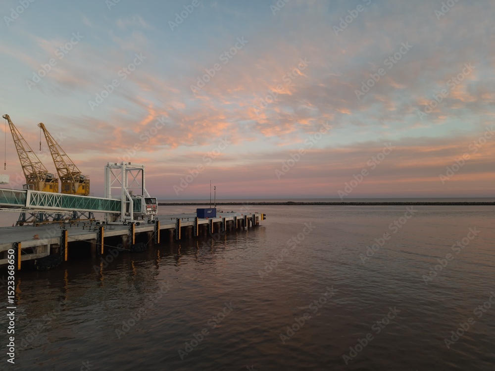 Fototapeta premium Pier on the La Plata River at sunset. Space for text. Copy space