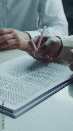 Businesspeople preparing to sign a legal document