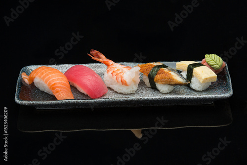 salmon, tuna, prawn, eel, tamago, nigiri sushi on a plate 