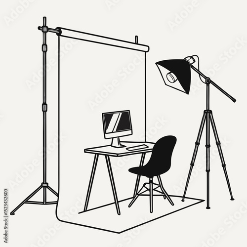 Home photography studio setup with backdrop lighting and computer