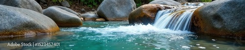 Refreshing cool water cascading over smooth, grey stones in a natural spring, creating a tranquil and serene atmosphere Crystal clear, icy cold, pure, natural, flowing water , energy, clean, quench
