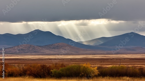 Sun rays over hilly autumn landscape